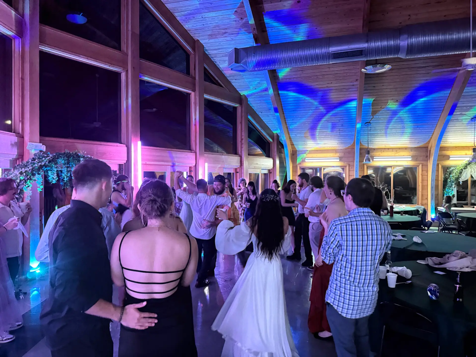 Wedding venue dance floor lit with uplighting