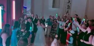 Newlyweds dancing with their family and friends.